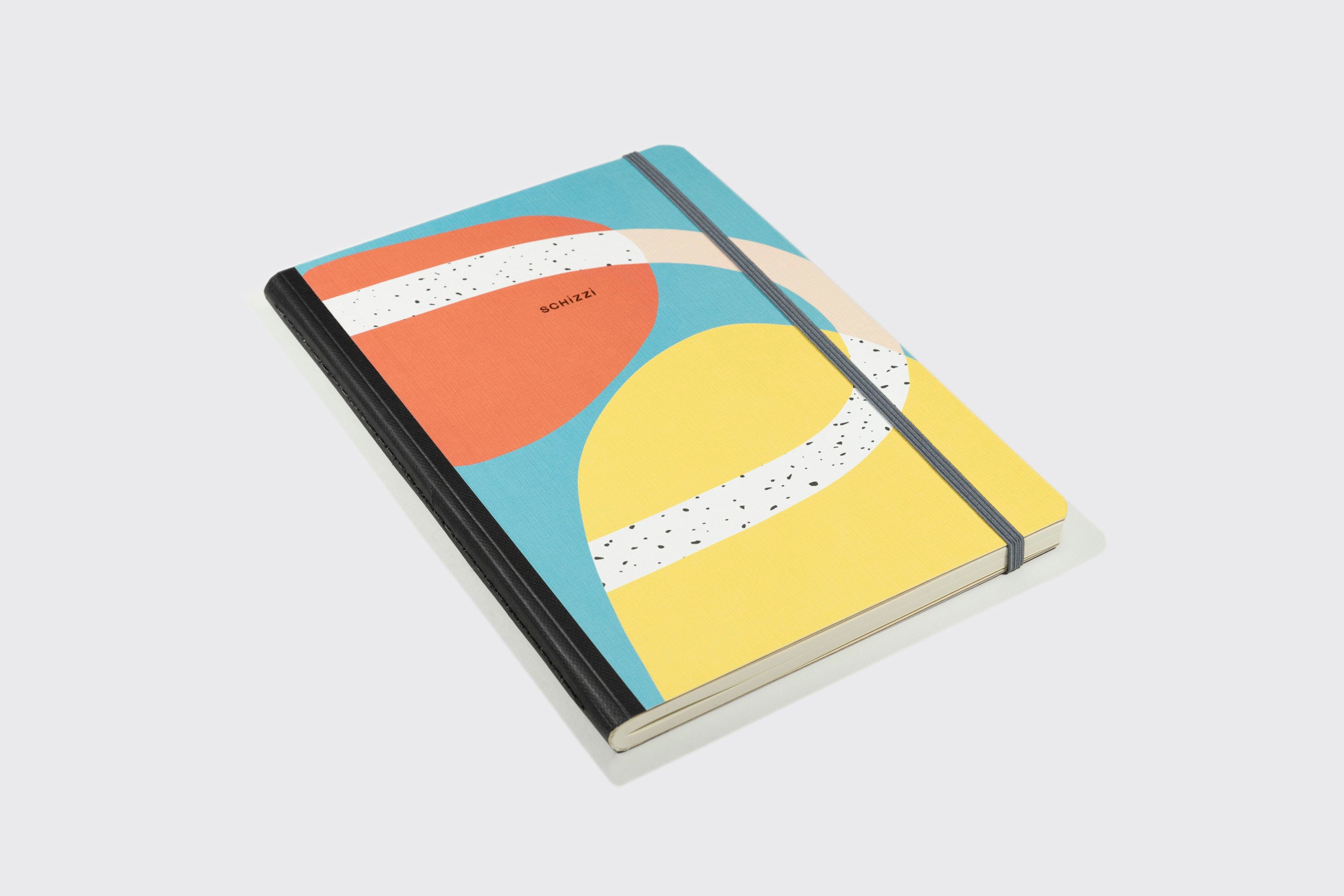 O Caderno de Desenhos Extra Grande da Schizzibooks é um caderno de desenho de capa dura com um design abstrato colorido em amarelo, azul, laranja e bege, com lombada preta, elástico e a palavra "WORKERS" impressa na capa. Feito com papel sem ácido para preservar sua arte.