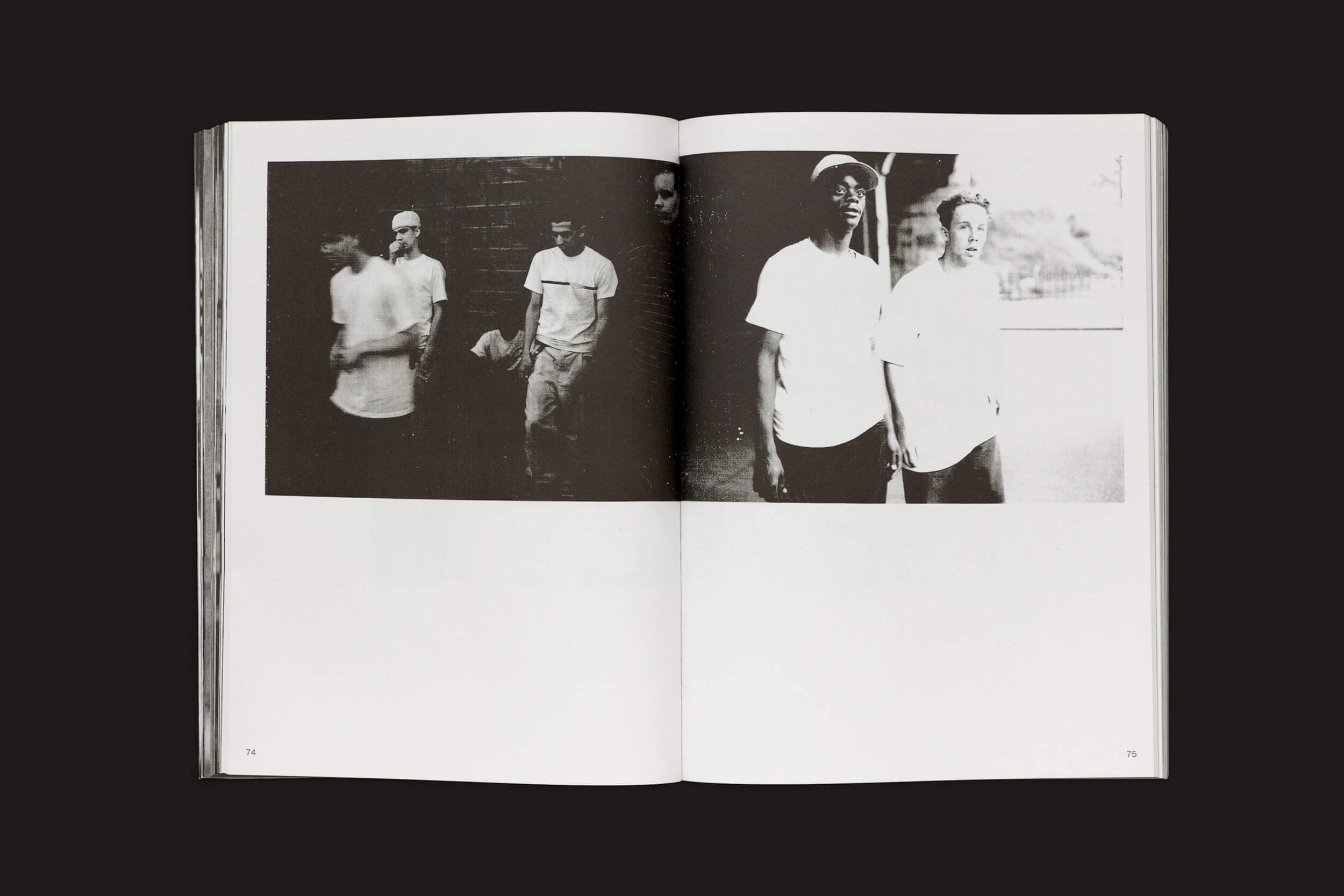 Um livro aberto intitulado Ari Marcopoulos: Beware da Roma Publications mostra duas fotografias granuladas em preto e branco. À esquerda, quatro pessoas estão de pé, uma delas segurando uma bola, sugerindo que podem ser patinadores em Nova York. A foto da direita captura dois indivíduos do lado de fora, uma reminiscência do estilo de Ari Marcopoulos.