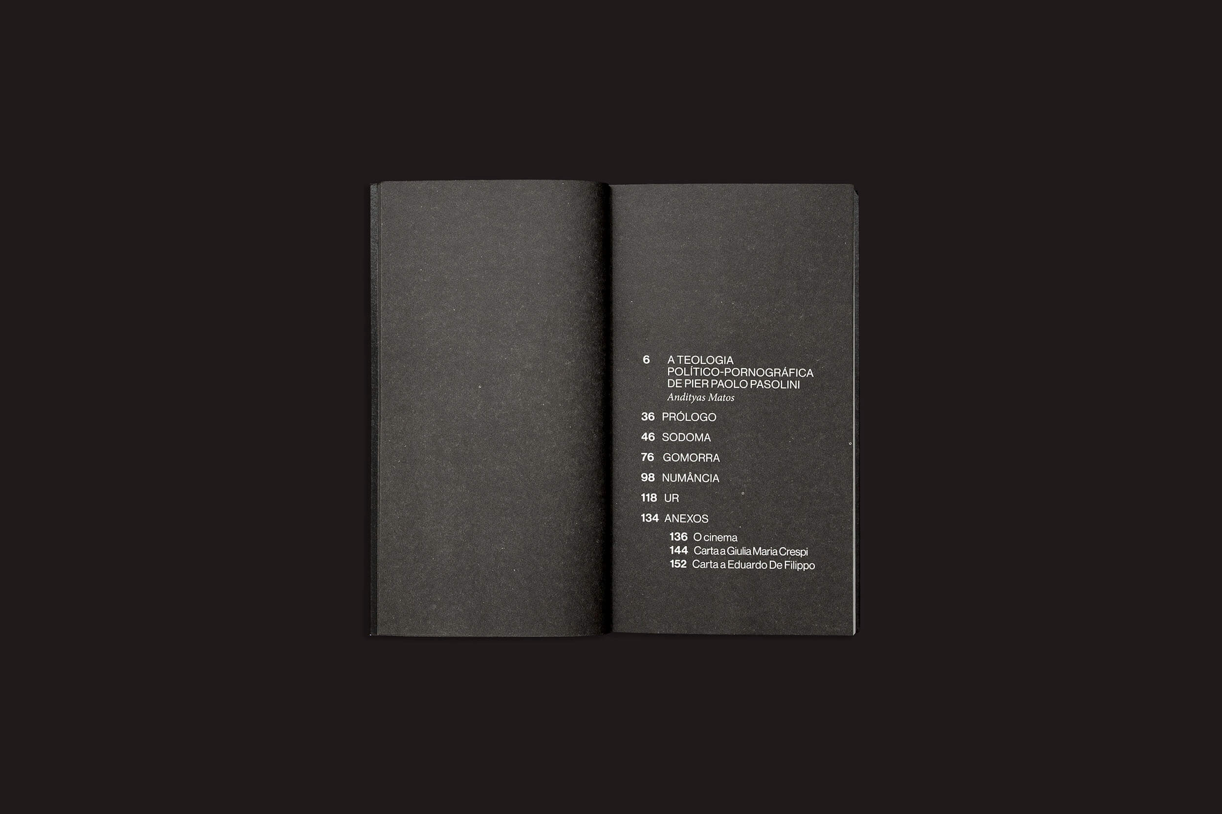 Um livro preto aberto em um fundo escuro exibe seu índice branco brilhante, com títulos como "Psicologia", "Sociologia", "Cosmologia" e "Numancia". Eles levam a um índice e conteúdo bônus inspirados nas utopias visionárias de Pier Paolo Pasolini. Produto: Pier Paolo Pasolini: Porno-Teo-Kolossal por sobinfluencia.