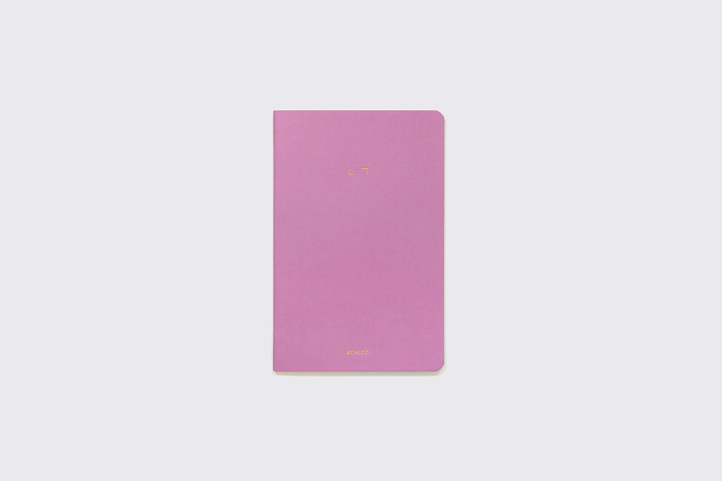 Um caderno rosa fechado, o "Caderno Flexível: Mirtilo" da Schizzibooks, repousa sobre um fundo cinza claro. Seu design minimalista inclui cantos arredondados e texto de capa sutilmente em relevo, combinando estilo com função.